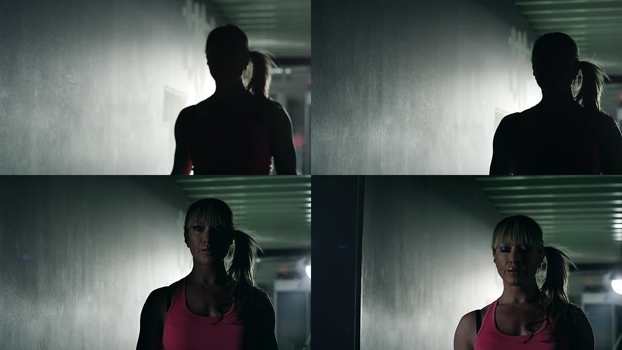 女健美运动员来健身房的剪影
