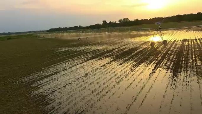 空中农业洒水装置在日落时浇灌田地