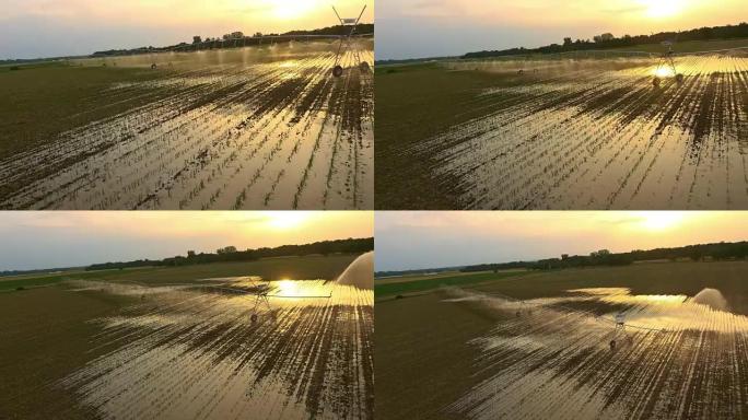 空中农业洒水装置在日落时浇灌田地