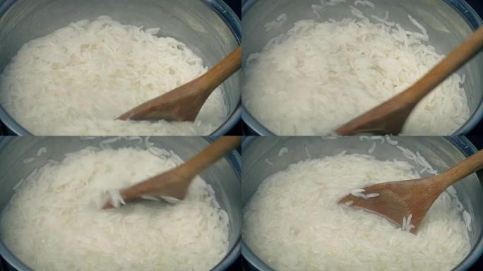 煮沸的米饭在锅中搅拌