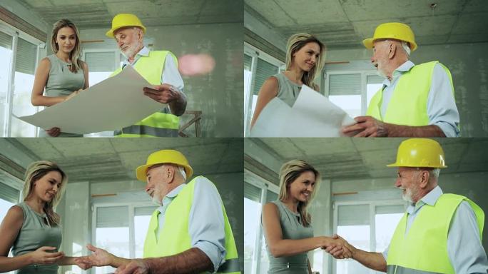 建筑师和客户工程师设计外国人装修图纸握手