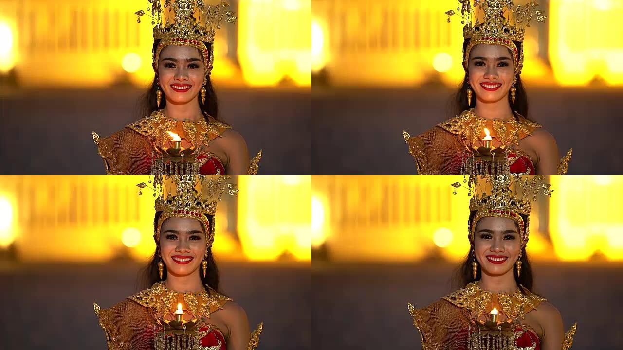 穿着泰国传统服装的亚洲妇女的肖像对着镜头微笑。