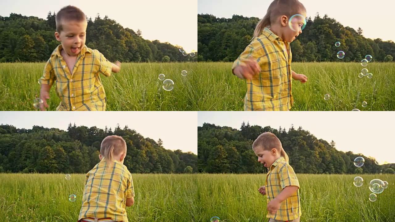 SLO MO男孩在草地上捕捉泡沫