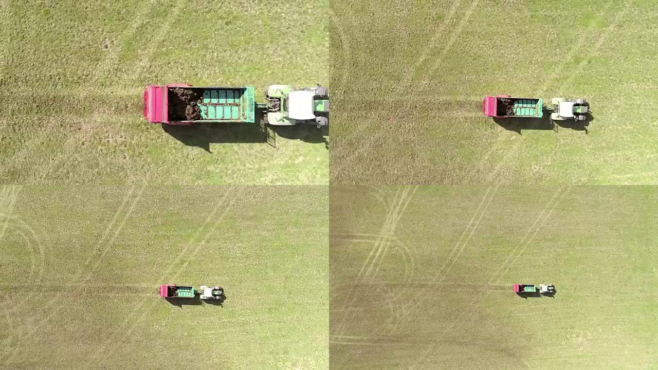 空中使用拖拉机将肥料撒在草地上