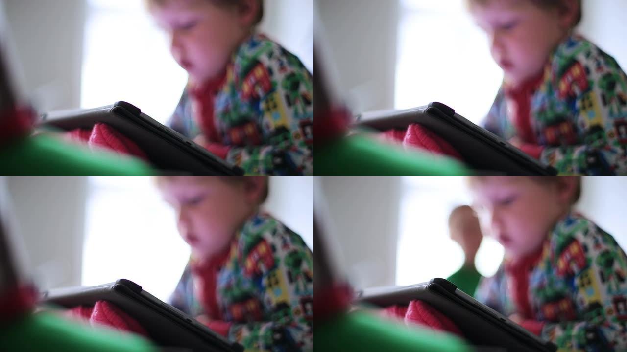 男孩在平板电脑上看动画片