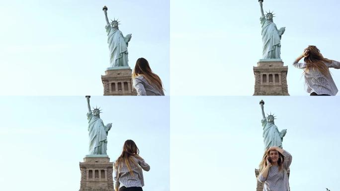 阳光明媚的日子，快乐迷人的微笑着的欧洲旅游女子在纽约自由女神像的电话里交谈