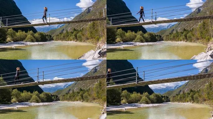 年轻女子在吊桥上穿越山涧