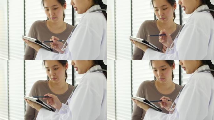 医生和病人在医院看数字平板电脑
