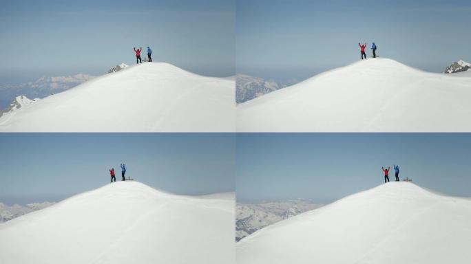 登山者在白雪覆盖的山峰上欢呼雀跃