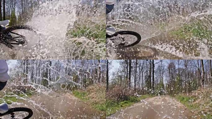 SLO MO特技骑自行车的人在水坑中漂流