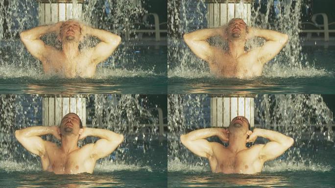 高清慢动作：肌肉发达的男子在温泉瀑布下放松