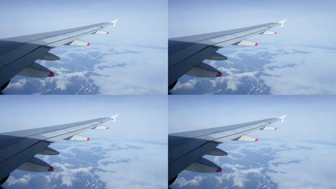 通过飞机窗户观看云海高空机翼机舱窗外