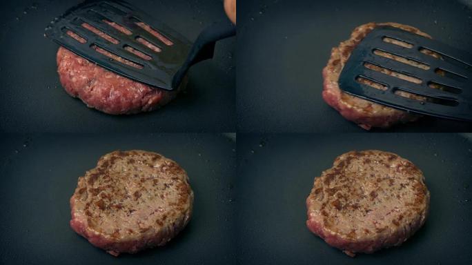 牛肉汉堡在锅中翻转