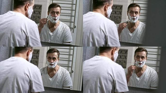 男人在浴室刮胡子时使用剃刀
