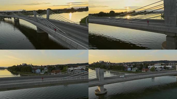 空中人在日落时慢跑过桥