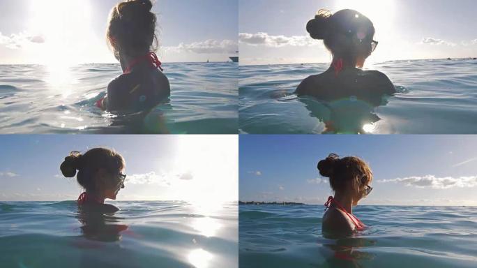 开朗的年轻女子在海洋中感到放松