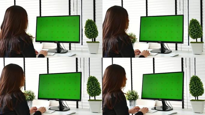 女商人使用带有绿屏、色度键的电脑