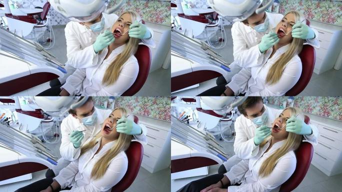 男牙医正在检查一位女病人。