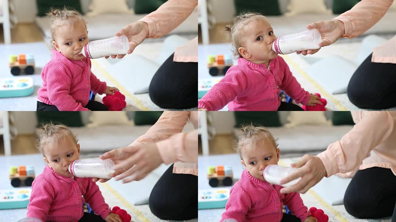 女人在游戏咖啡馆里给婴儿喂牛奶