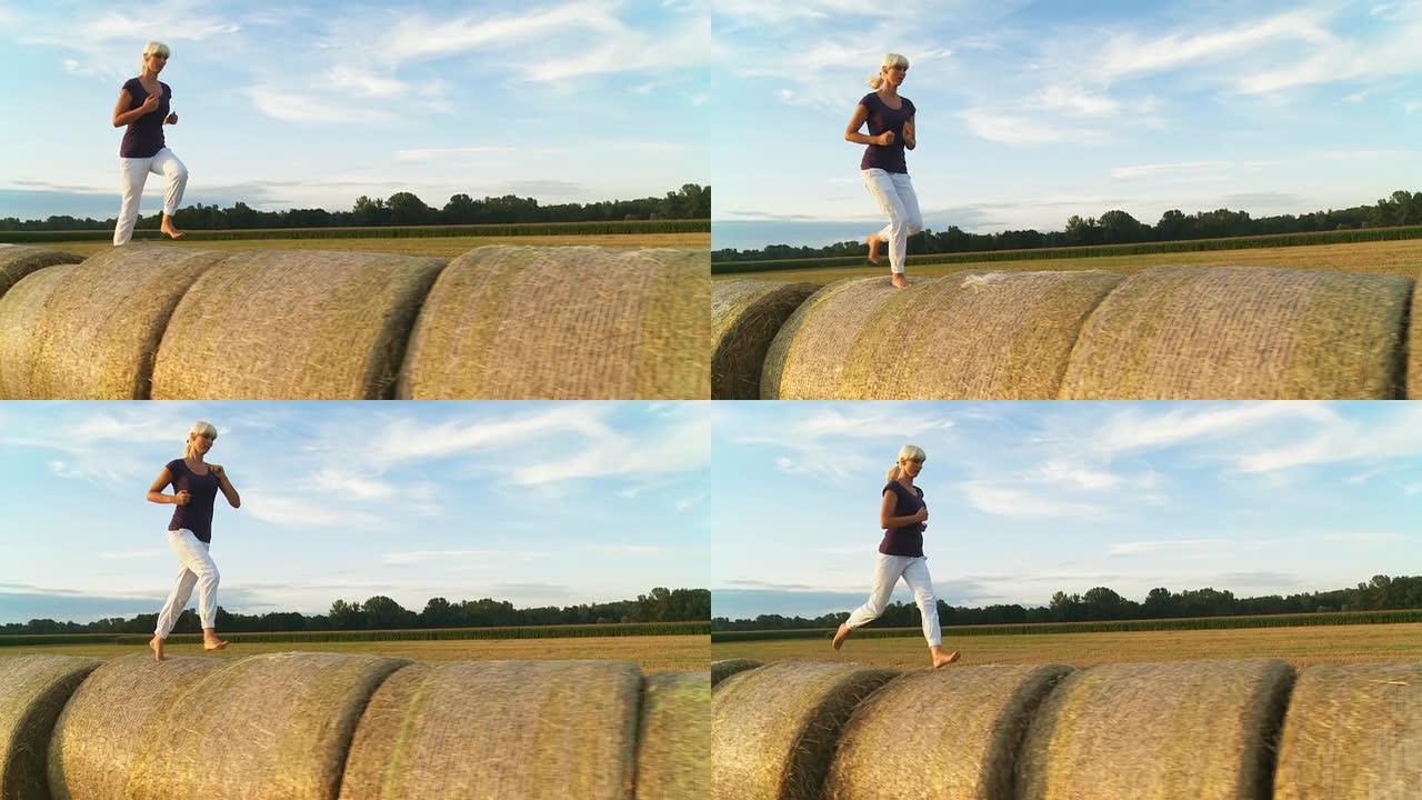 高清稳定镜头：女人在干草捆上奔跑