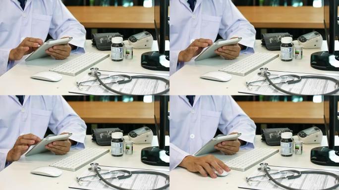医生在医院的办公桌上使用数字平板电脑