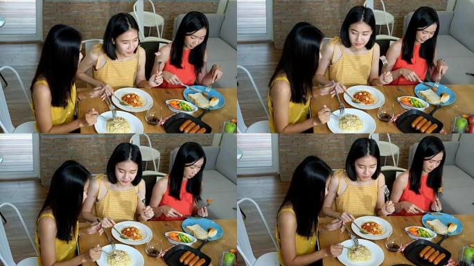 亚洲女性朋友小组在意大利食物，香肠和沙拉中共进午餐