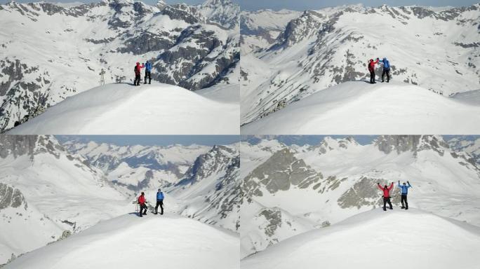 登山者在白雪覆盖的山峰上欢呼雀跃