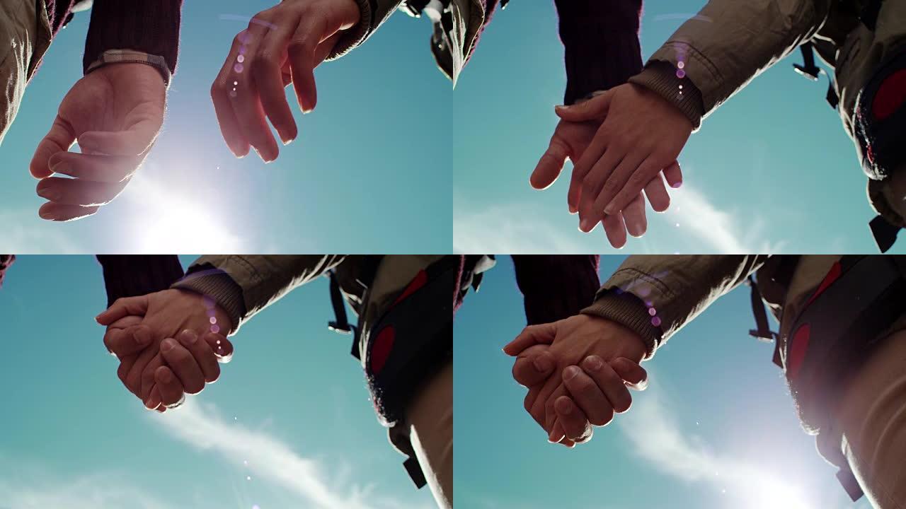 牵手的年轻夫妇握手牵手阳光下牵手