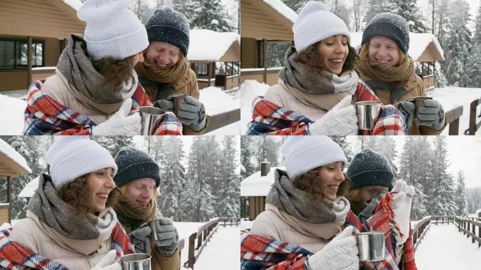在冬季森林里，笑着的夫妇在户外喝茶