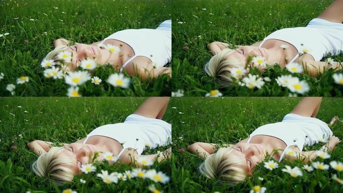 一个年轻女人睡在新鲜的绿草里
