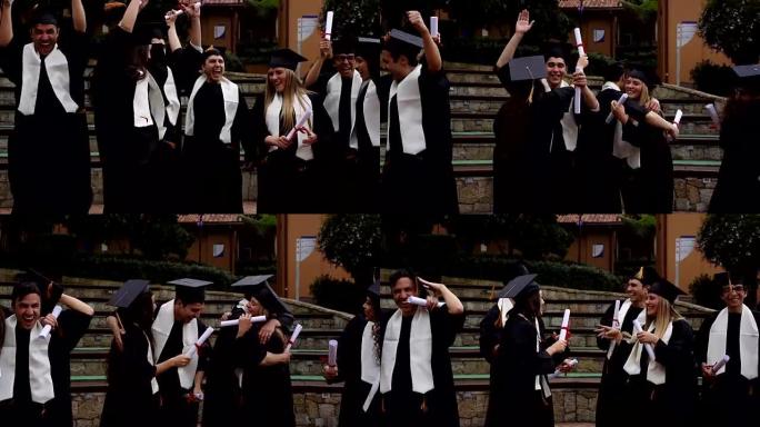校园里的年轻学生在毕业典礼上庆祝跳跃和拥抱