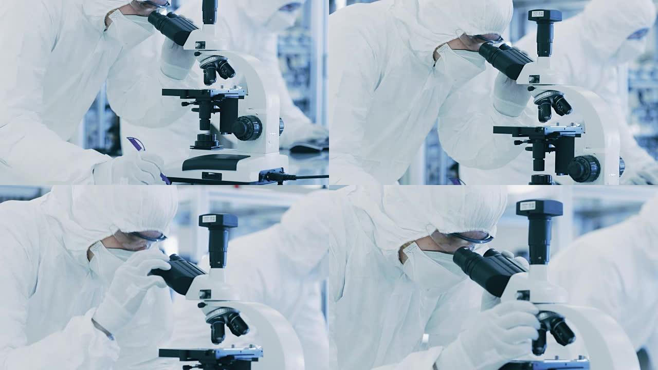 在实验室里，科学家穿着防护服做研究，用显微镜写下数据。在生产半导体和药品的现代工厂工作的工人。