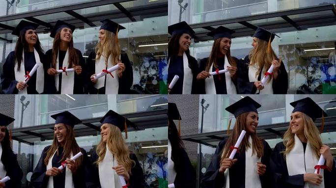 毕业典礼后离开校园的一群美丽的女性朋友都拿着学位说话