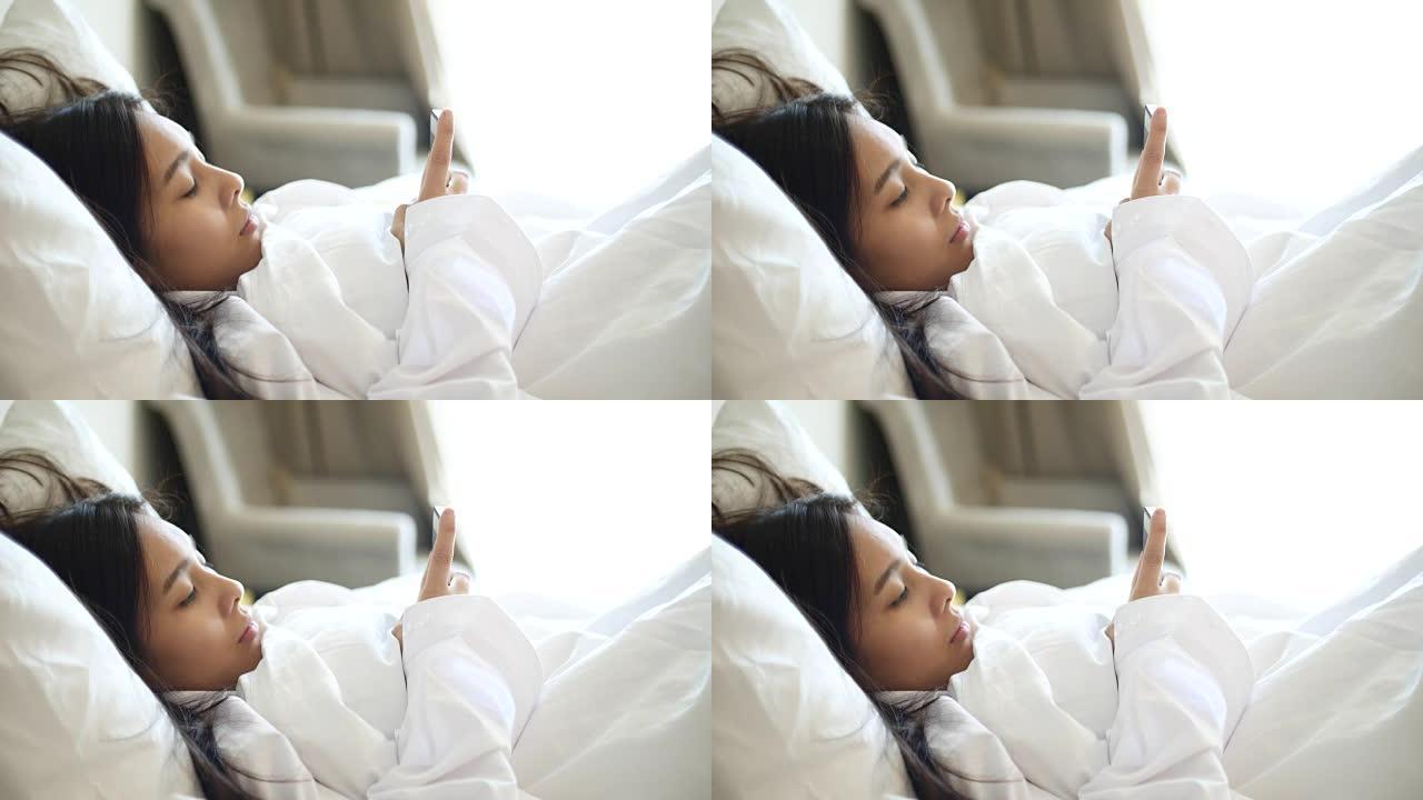 年轻女子在床上使用智能手机