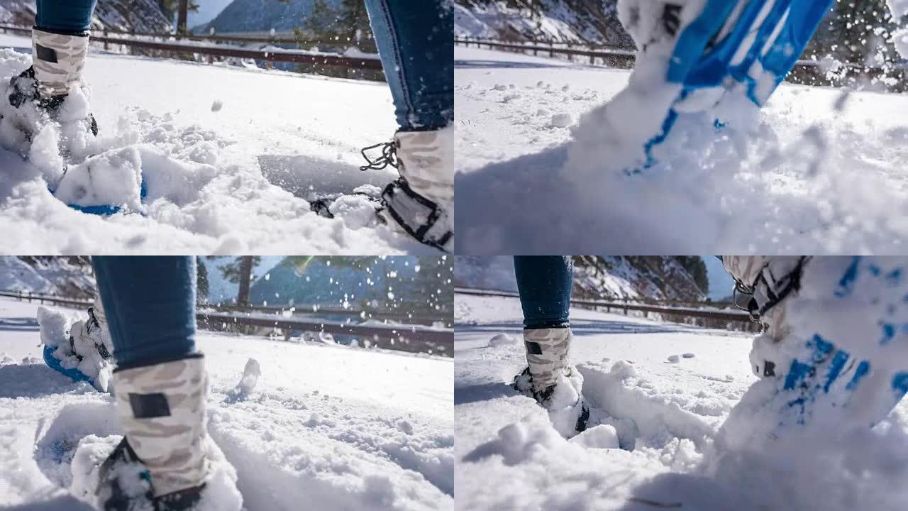 女人雪鞋在新鲜的雪上行走