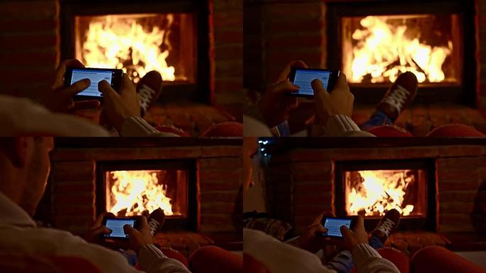 DS男子在壁炉旁使用手机