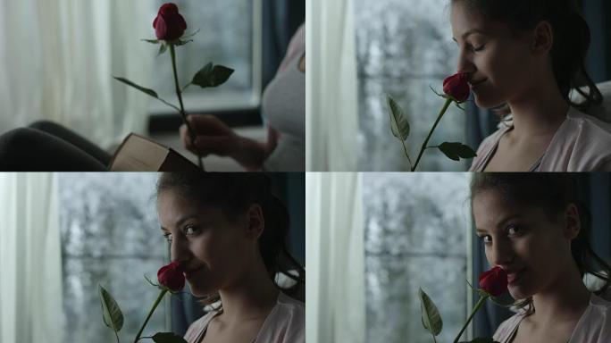 闻红玫瑰的年轻女子