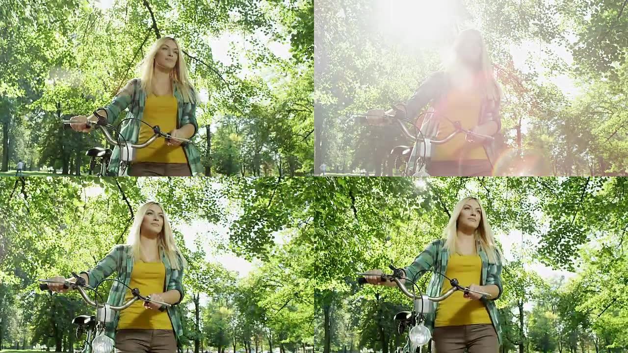 漂亮的女人推着自行车穿过公园