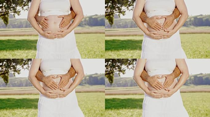 DS手在怀孕的腹部形成心形