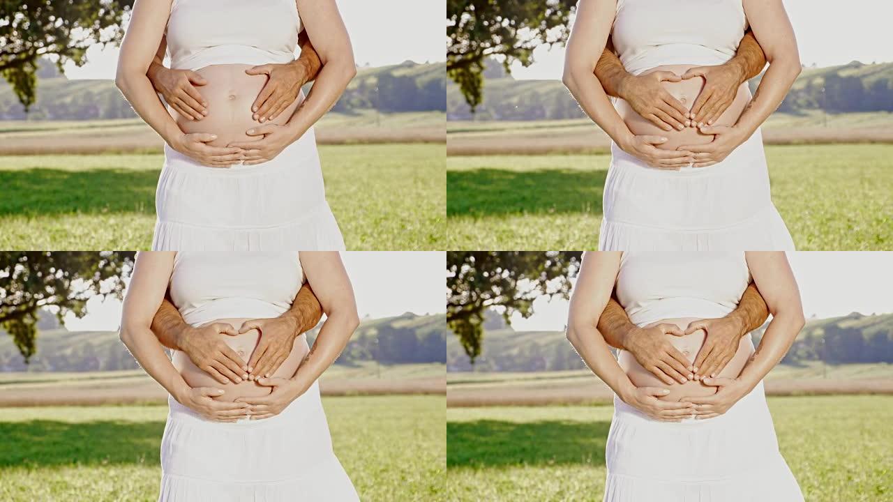DS手在怀孕的腹部形成心形