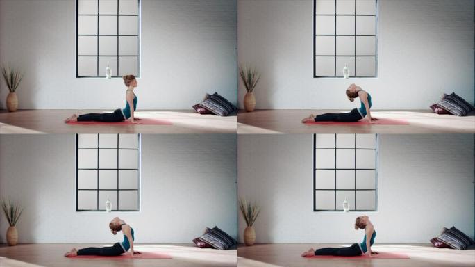 女人在健身房练习瑜伽 (朝上的狗姿势)