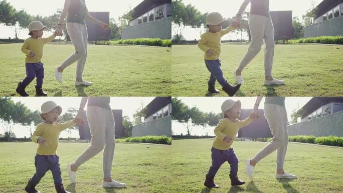 兴奋的亚洲男孩和他的母亲在公园跑步