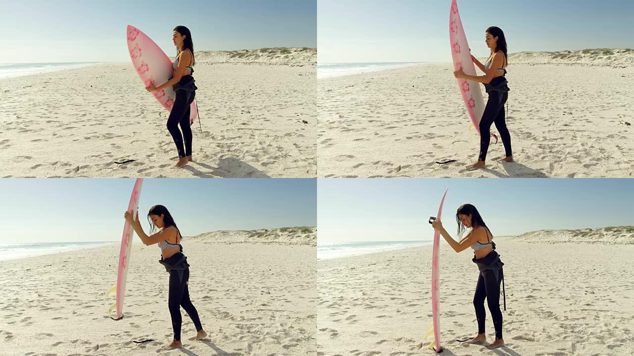 女冲浪者把冲浪板放在沙子里4K 4k