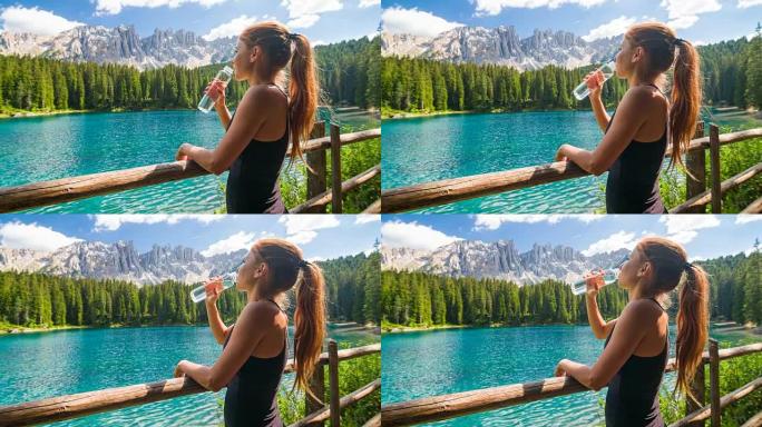 多洛米蒂山脉拉戈迪卡雷扎山的快乐女游客享受着令人惊叹的景色，饮用水