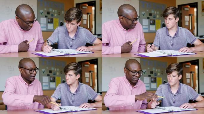高中导师在办公桌上给男学生一对一的学费