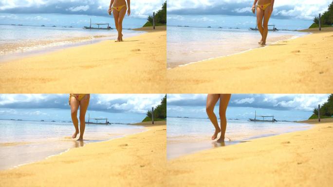 WS DS行走在萨努尔海滩上的女人