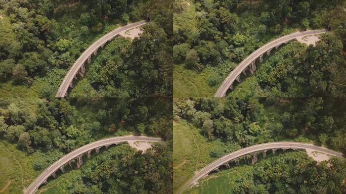 空中全景俯视图，无人机在斯里兰卡的九拱桥埃拉在异国情调的郁郁葱葱的绿树中左转