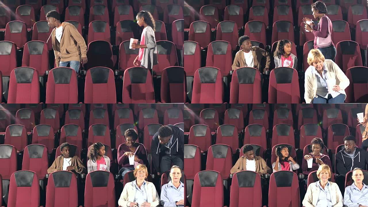 人们进入电影院，寻找座位