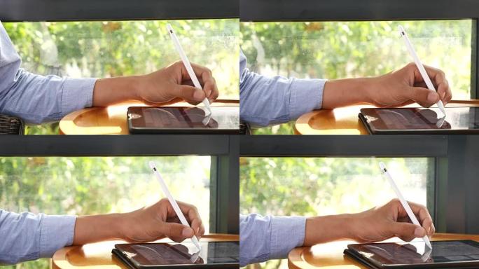 在平板电脑上使用数字笔书写的人