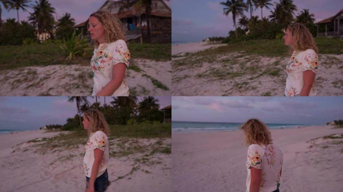 Steadycam拍摄的年轻女子在沙滩上行走